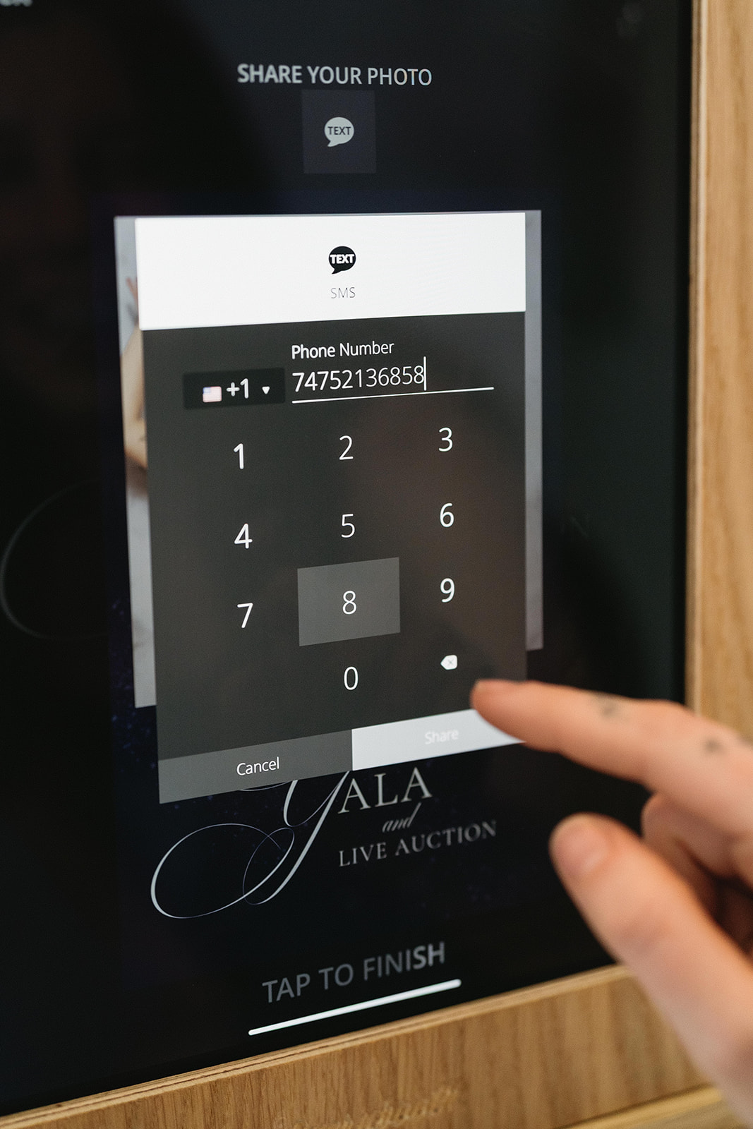 The booth's branded sharing screen at a gala and live auction