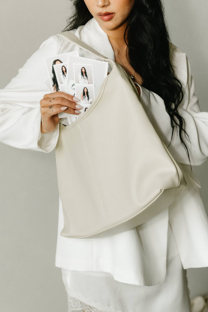 A guest tucking a strip of portrait prints into her handbag