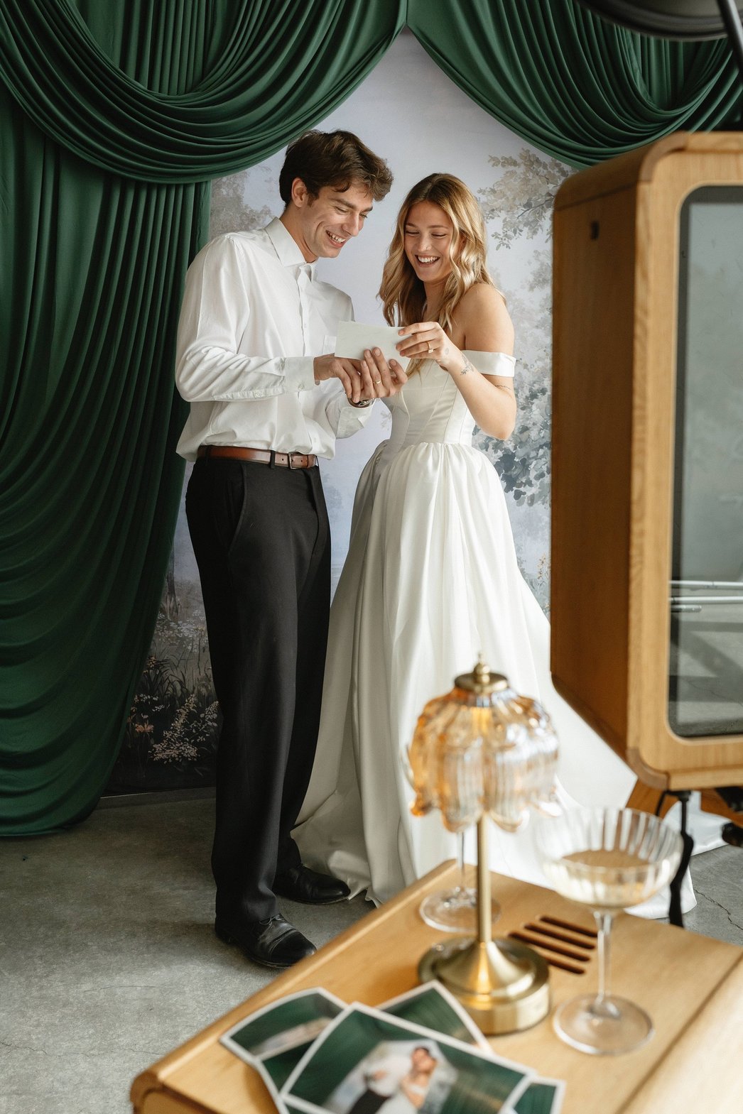 A couple holding their printed booth photos