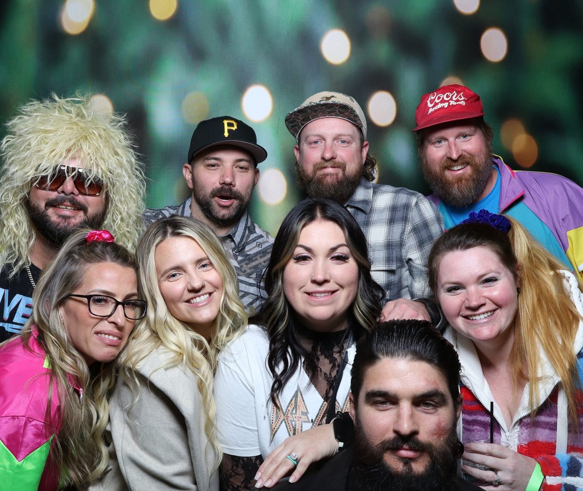 A company holiday party crowd in neon costume at the booth