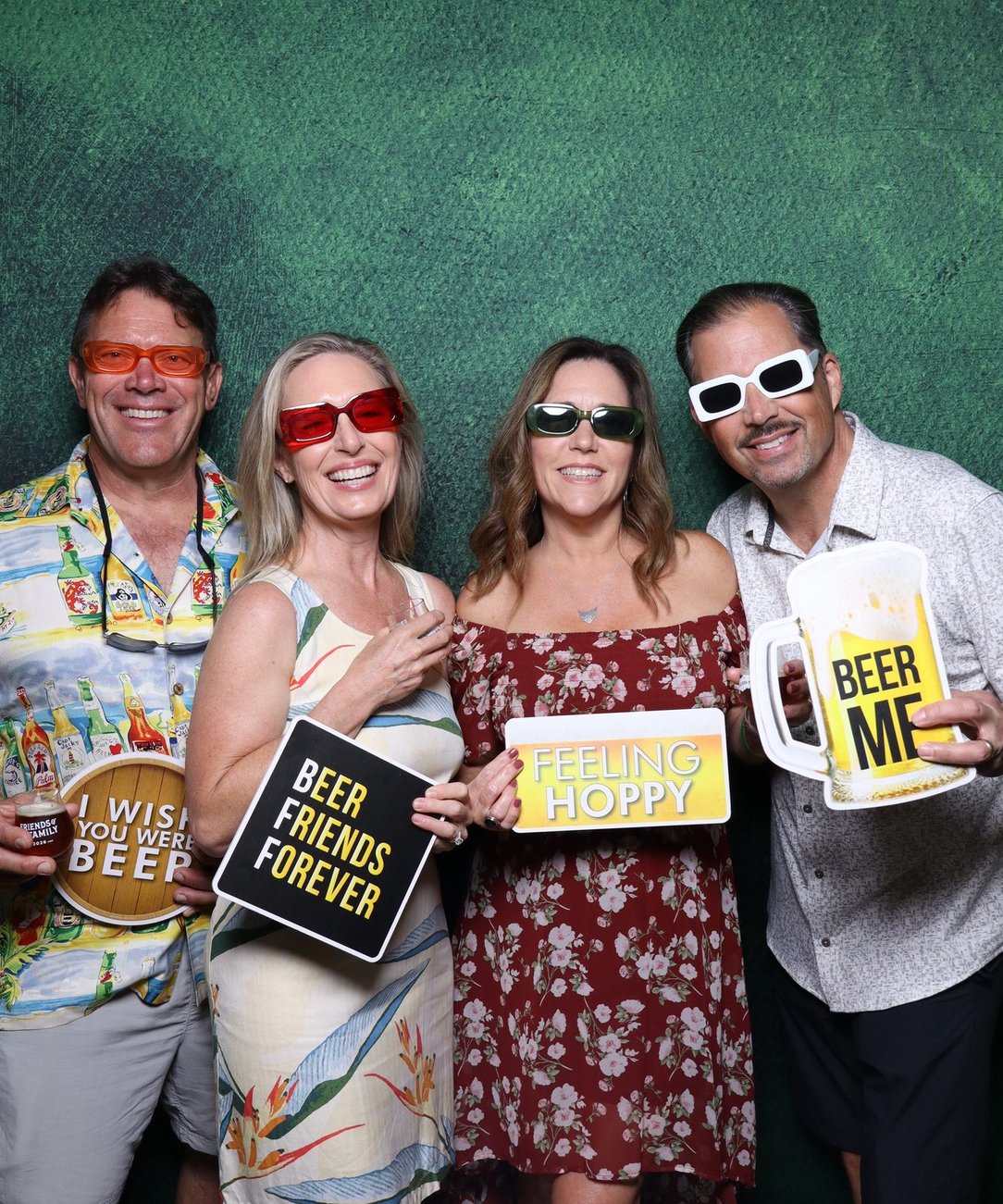 Four colleagues holding branded signs at the booth