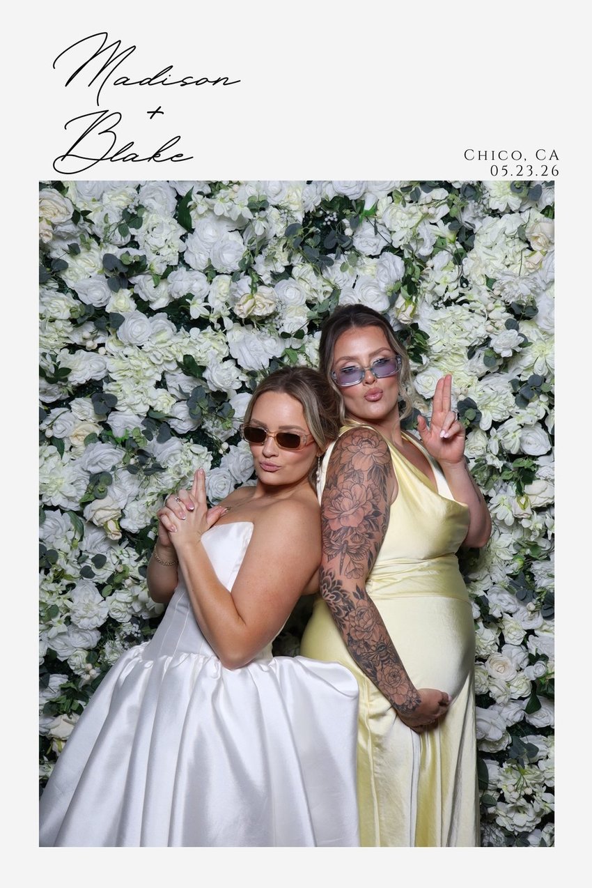 A Madison and Blake wedding print of two guests at the flower wall