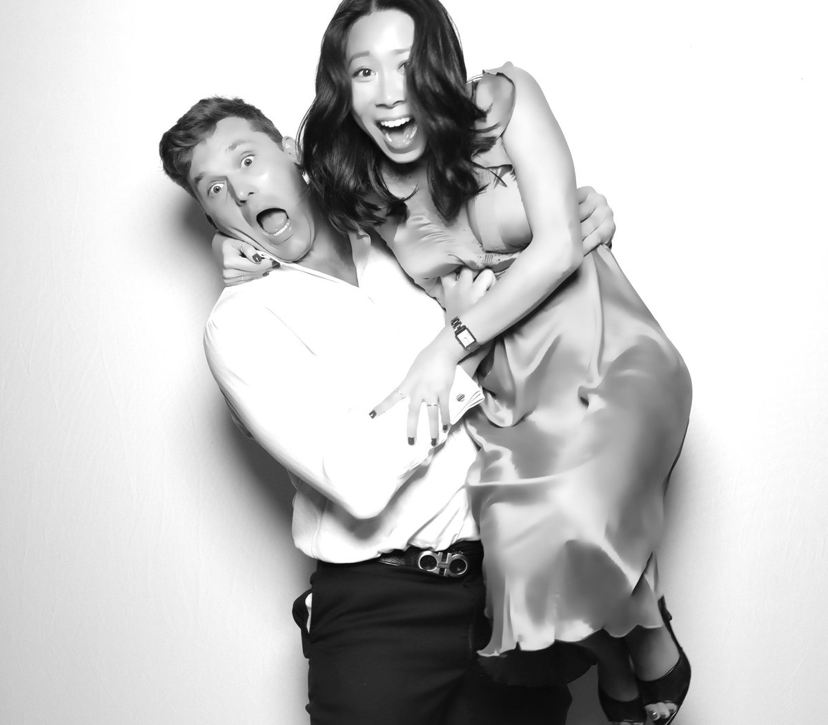 A guest lifting his partner in a black and white studio shot